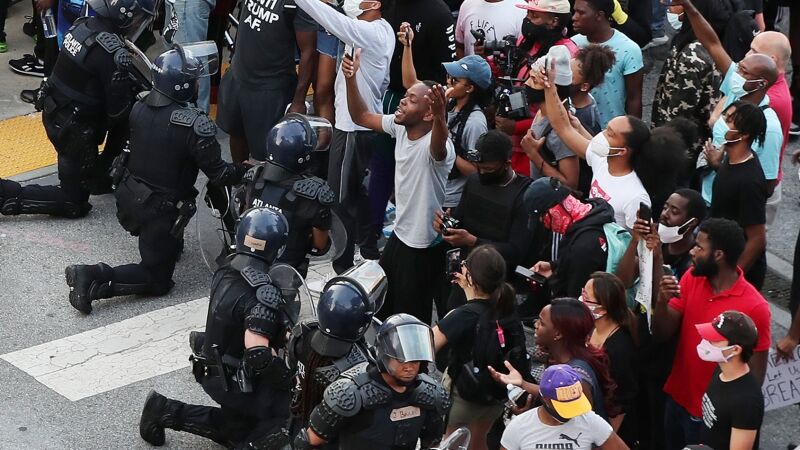 Подняли бунт против. Американская полиция на коленях. Полицейские на коленях в США. Полицейские США целуют ботинки неграм.